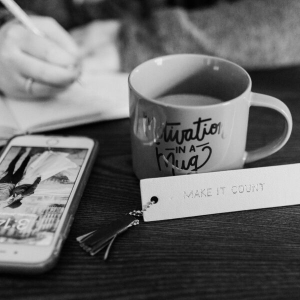 Phone and coffee mug on desk.