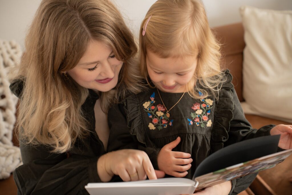 Mom reading book to daughter. 