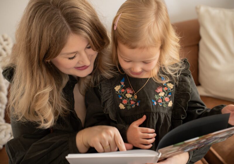 Mom reading book to daughter.